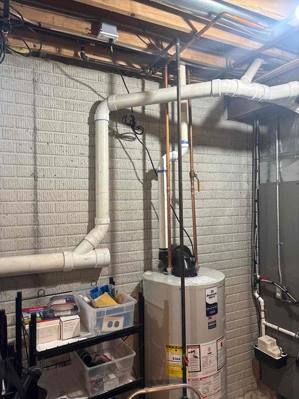 Installed dedicated 120V electrical circuit for power-vent water heater in basement utility area. Ran new electrical wiring from main panel through exposed ceiling joists to water heater location, securing cable properly along structural members. Mounted weatherproof electrical box and installed GFCI-protected outlet adjacent to water heater to provide power for exhaust blower motor. Verified proper grounding, tested circuit functionality, and confirmed adequate clearances per manufacturer specifications and local electrical code requirements.