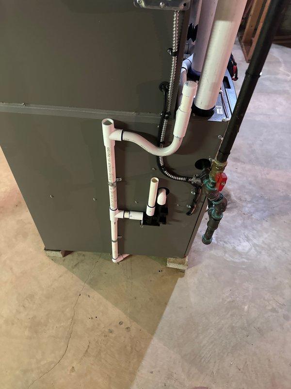 Completed full HVAC system installation including a 70,000 BTU furnace and 2-ton air conditioning unit in rear configuration. Installed all necessary PVC venting through exterior wall, connected refrigerant lines, established proper condensate drainage, and verified all gas and electrical connections. System tested and operational with all components properly secured and meeting code requirements.
