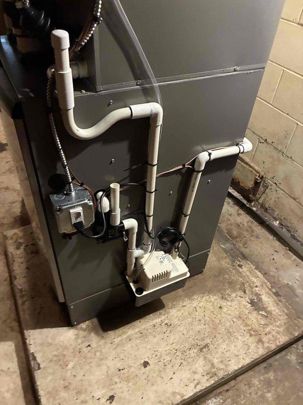 # Complete HVAC System Installation

Successfully completed full residential HVAC system installation including a 110,000 BTU furnace and 4-ton air conditioning unit with rear discharge configuration. The installation was performed in the basement utility area with all equipment properly positioned and secured on the concrete floor foundation.

## Equipment Installed

- 110,000 BTU gas furnace with complete venting system
- 4-ton air conditioning condenser unit with rear discharge
- Whole-home humidifier integrated with furnace system
- Condensate pump and drainage system
- All necessary electrical disconnects and controls

## Work Performed

Removed existing HVAC equipment and prepared installation area. Positioned new furnace unit in basement location with proper clearances for service access and ventilation requirements. Installed flexible venting system using appropriate materials for combustion air intake and exhaust. Connected gas supply line to furnace with proper shut-off valve
