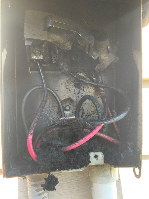 Responded to no cooling call on 10+ year old system. Upon arrival, found outdoor unit completely inoperative with visible burn marks around exterior disconnect box and on mounting surface. Inspection revealed extensive electrical damage with heavy soot and carbon deposits throughout disconnect enclosure, indicating significant arcing event. Internal components showed severe deterioration with tarnished terminals and blackened surfaces. Outdoor unit contactor also exhibited signs of electrical failure with discolored wiring connections and aged components. Documented damage with photos for customer review. System deemed unsafe to operate due to extent of electrical damage. Provided repair options including disconnect box replacement, contactor replacement, and full electrical system evaluation to determine source of failure and prevent recurrence.