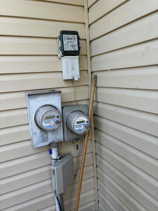 Conducted comprehensive site assessment for air conditioning system replacement at residential property. Documented existing electrical infrastructure including main service panel with 200-amp capacity, verified circuit breaker configuration and labeling for HVAC equipment compatibility, and photographed exterior meter base and electrical service entrance to ensure adequate power supply for proposed equipment installation.