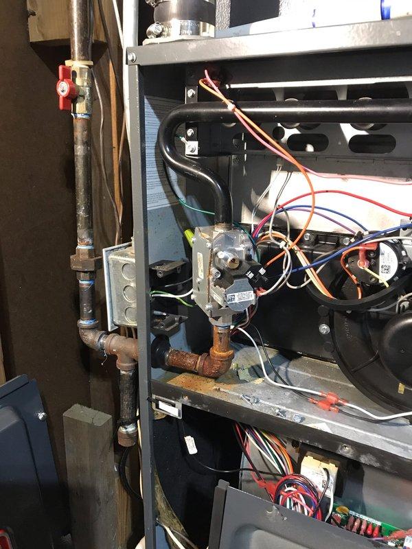 Completed comprehensive air conditioning tune-up and system inspection as part of prepaid maintenance agreement. Performed standard preventive maintenance procedures including inspection of blower motor assembly, gas valve connections, electrical components, and control board wiring. Documented existing corrosion on copper gas piping near valve connection and normal operational wear on metal components. All systems operational upon completion with findings photographed for records.