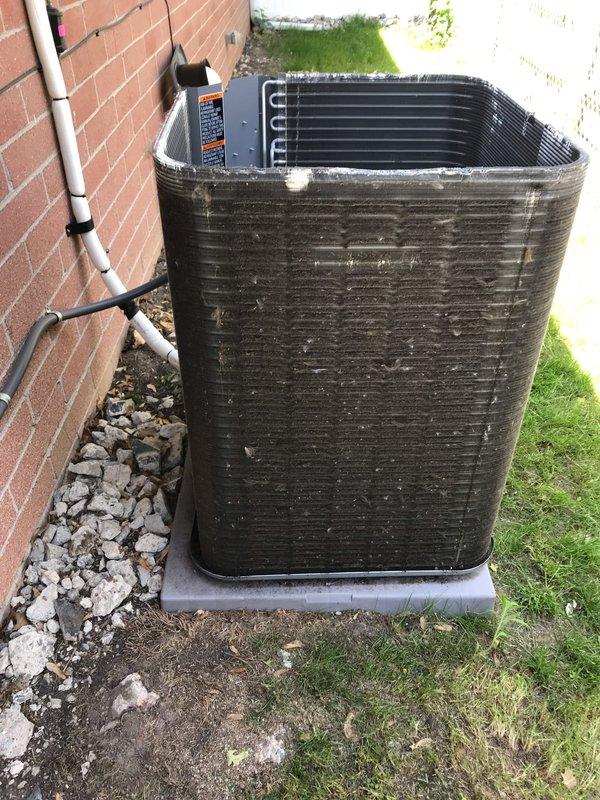 Completed prepaid air conditioning maintenance tune-up on residential split system. Performed comprehensive inspection of outdoor condenser unit, which showed significant accumulation of dirt, dust, and debris on aluminum fins and exterior surfaces. Cleaned condenser coils to restore proper heat transfer efficiency and airflow. Inspected electrical connections, refrigerant lines, and condensate drain system. Verified unit operation and documented pre-existing condition showing weathering and environmental buildup consistent with extended service without regular maintenance. All system components functioning properly upon completion of tune-up service.