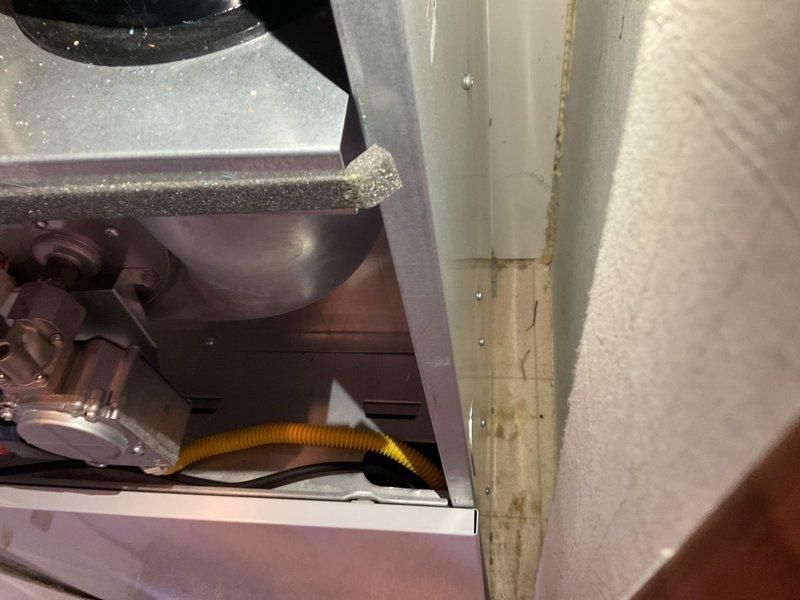Provided comprehensive HVAC replacement estimate for existing air handler unit located in interior closet space. Evaluated current white metal furnace/air handler installation, assessed mechanical components including blower assembly and drainage system with yellow flexible condensate line, and documented equipment condition showing normal operational wear. Generated multiple quote options (03752-02, 03752-03) for complete system replacement to address customer's cooling and heating needs.