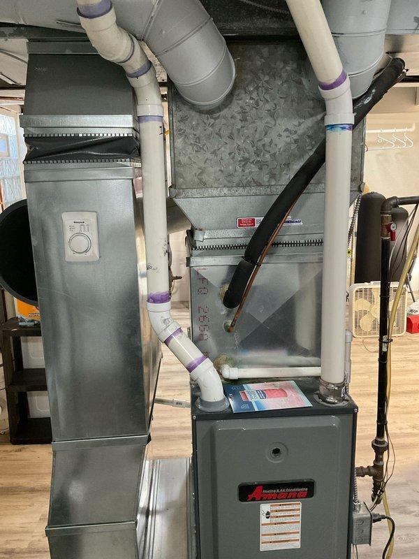 Completed on-site assessment for full HVAC system replacement at single-family residence. Evaluated existing 20-year-old furnace located in basement and 10-year-old central air conditioning unit positioned outside. Documented current split system configuration serving entire home, photographed existing equipment installation including furnace with control panel, PVC ventilation piping, metal ductwork transitions, and air handler components. Provided comprehensive replacement estimate for planned upgrade of both heating and cooling equipment.