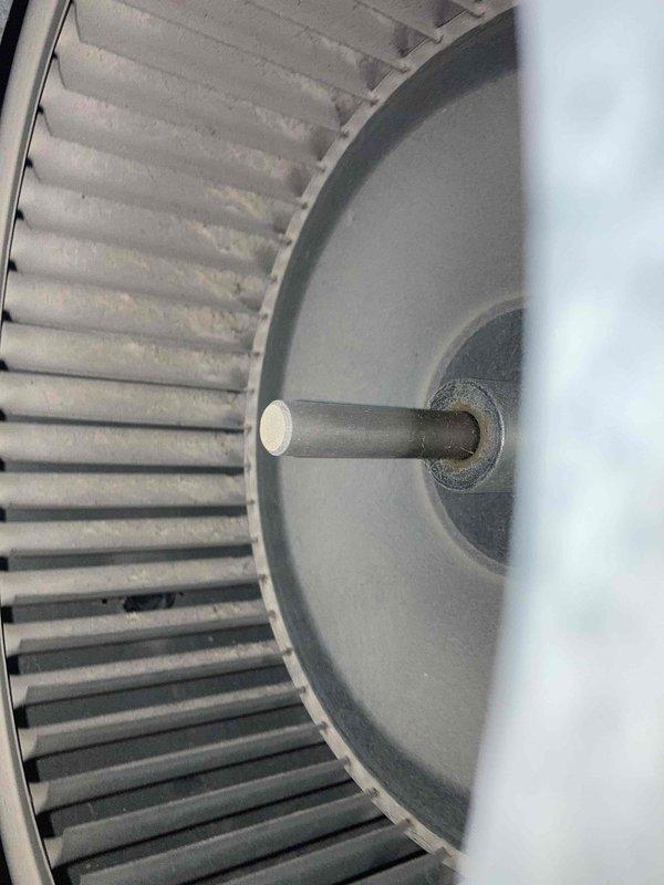 Completed Club AC12-4 preventive maintenance agreement visit on split system air conditioning unit. Performed thorough inspection of blower assembly, noting dust accumulation on squirrel cage fan blades and motor shaft. Verified electrical readings using digital multimeter, recording 126.2 volts at system components to ensure proper voltage supply and operational parameters within manufacturer specifications.
