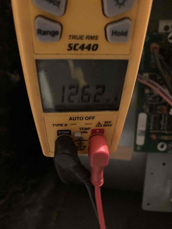 Completed Club AC12-4 preventive maintenance agreement visit on split system air conditioning unit. Performed thorough inspection of blower assembly, noting dust accumulation on squirrel cage fan blades and motor shaft. Verified electrical readings using digital multimeter, recording 126.2 volts at system components to ensure proper voltage supply and operational parameters within manufacturer specifications.