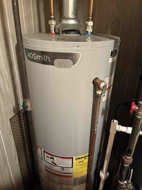 Conducted on-site evaluation for HVAC system replacement estimate. Documented existing electrical service panel with 200-amp breaker box and disconnect, noting proper conduit routing and meter installation. Assessed current AOsmith Signature 100 water heater installation with copper supply lines, shut-off valves, and PVC drainage connections in utility room. Photographed equipment configurations and mechanical room layout to provide comprehensive system replacement proposal for single component estimate.