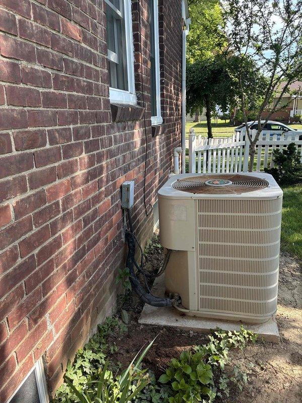 Performed estimate for replacement of 14-year-old Westinghouse R22 residential cooling system found to be undercharged. Evaluated outdoor condensing unit positioned on concrete pad against brick exterior wall, assessed refrigerant line connections and electrical conduit routing. Provided single component estimate and complete system replacement quote options due to age of equipment and obsolete R22 refrigerant.