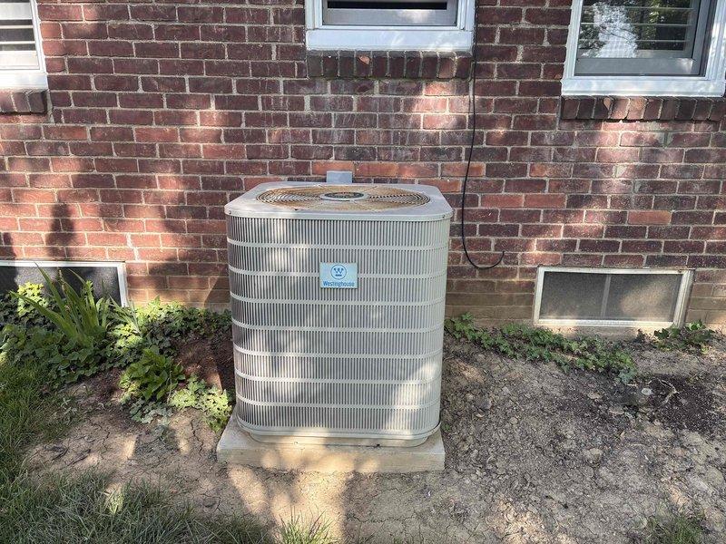 Performed estimate for replacement of 14-year-old Westinghouse R22 residential cooling system found to be undercharged. Evaluated outdoor condensing unit positioned on concrete pad against brick exterior wall, assessed refrigerant line connections and electrical conduit routing. Provided single component estimate and complete system replacement quote options due to age of equipment and obsolete R22 refrigerant.