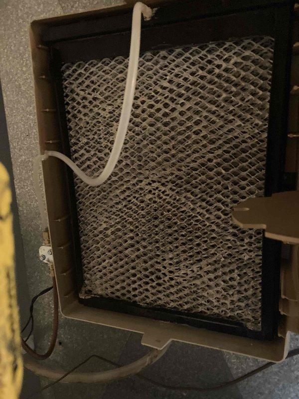 Completed seasonal air conditioning maintenance and system inspection under club agreement. Performed electrical diagnostics using digital multimeter, recording voltage readings of 496.3V on system components, and inspected control wiring connections within the equipment cabinet. Found evaporator coil and air filter heavily clogged with dust and debris accumulation, restricting airflow through the system; filter requires immediate replacement to restore proper system operation and efficiency.
