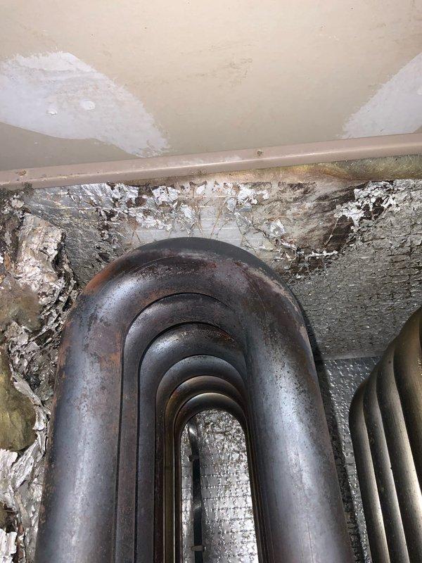 # HVAC Service Completion

Responded to no-cooling complaint on aging residential air conditioning system. Upon arrival, confirmed unit was blowing warm air with no refrigeration cycle operation. Conducted visual inspection of evaporator coil assembly and found significantly deteriorated cabinet interior with extensive surface degradation, peeling insulation, and accumulated debris affecting airflow efficiency.

Accessed control board compartment and performed electrical diagnostics on multi-relay control system. Tested voltage at all terminal connections and verified proper power supply to board. Inspected numerous control wiring connections across multiple circuits including thermostat wiring, safety controls, and component connections. Evaluated condition of capacitors, relays, and other electrical components mounted to control board.

Given the age of the system (10+ years) and the extent of deterioration observed in the cabinet interior, discussed system condition and repair optio