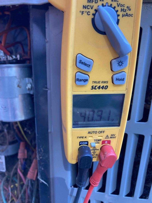 Completed CLUB AC 4-6 preventive maintenance agreement visit on residential air conditioning system. Performed comprehensive inspection of outdoor condensing unit, documented system operating parameters with digital multimeter showing 903.1 reading, and assessed refrigerant line connections at base of unit which displayed normal weathering and oxidation consistent with outdoor exposure. All components operating within acceptable parameters at time of inspection.