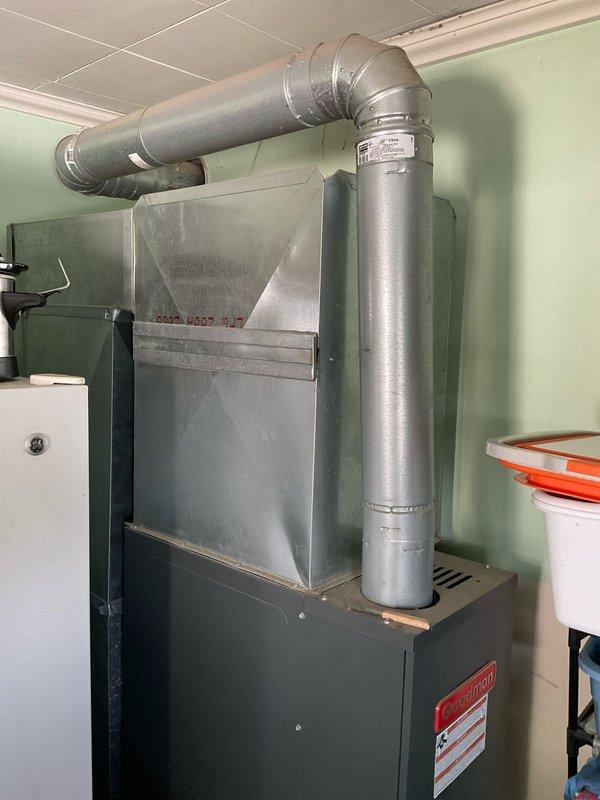 Completed comprehensive estimate for replacement of existing residential HVAC system including outdoor air conditioning condenser unit and indoor furnace installation. Assessed current equipment condition, noting vegetation growth on condenser unit, weathered refrigerant lines with patina buildup, and aging disconnect box with rust accumulation. Evaluated indoor furnace system with existing ductwork configuration and provided recommendations for complete system replacement to improve efficiency and reliability.