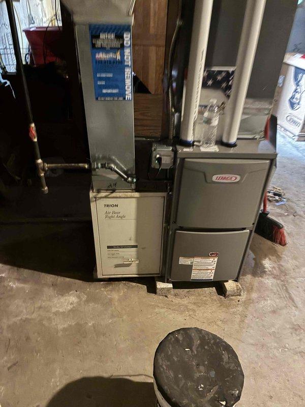 Completed installation of 70,000 BTU Lennox furnace system in basement utility area, including all mechanical and electrical connections. Installed Trion Air Four Right Angle air handler with filtration system, connected rigid and flexible ductwork, and reconnected all necessary utilities to restore full HVAC operation.