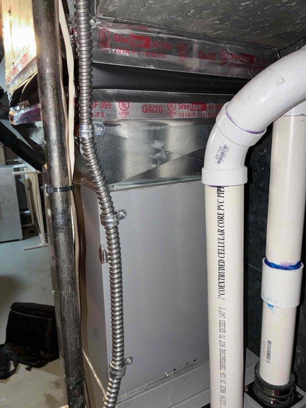 Conducted comprehensive HVAC system evaluation for replacement estimate, assessing both existing indoor air handler unit located in basement utility area and outdoor condenser unit positioned at exterior brick wall. Documented current system configuration including ductwork connections, electrical conduit routing, PVC condensate drainage piping with proper securing, and exterior electrical service connections. Provided detailed quote options for single component replacement and complete system replacement to address equipment replacement needs.