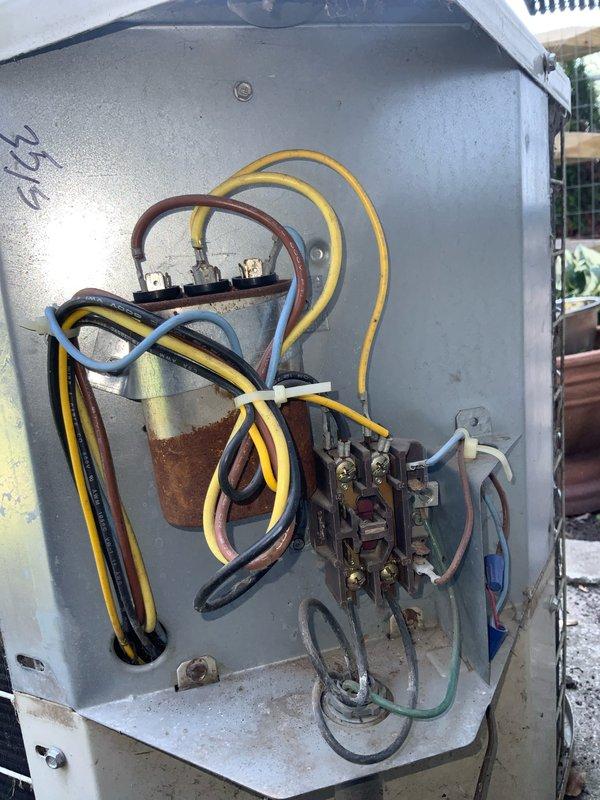 Responded to no cooling complaint on residential air conditioning system. Upon inspection, found significant corrosion and oxidation on contactor assembly and internal electrical components within outdoor unit control panel. Contactor showed brownish-orange discoloration indicating electrical resistance and failure, preventing compressor from operating properly. Fans operated normally, confirming power supply to unit, but compressor circuit was compromised due to corroded contacts. Replaced failed contactor and inspected all electrical connections for integrity. Cleaned corrosion from mounting surfaces and terminal connections. Verified proper voltage at all connection points and confirmed compressor operation. System restored to normal cooling operation with all components functioning as designed.