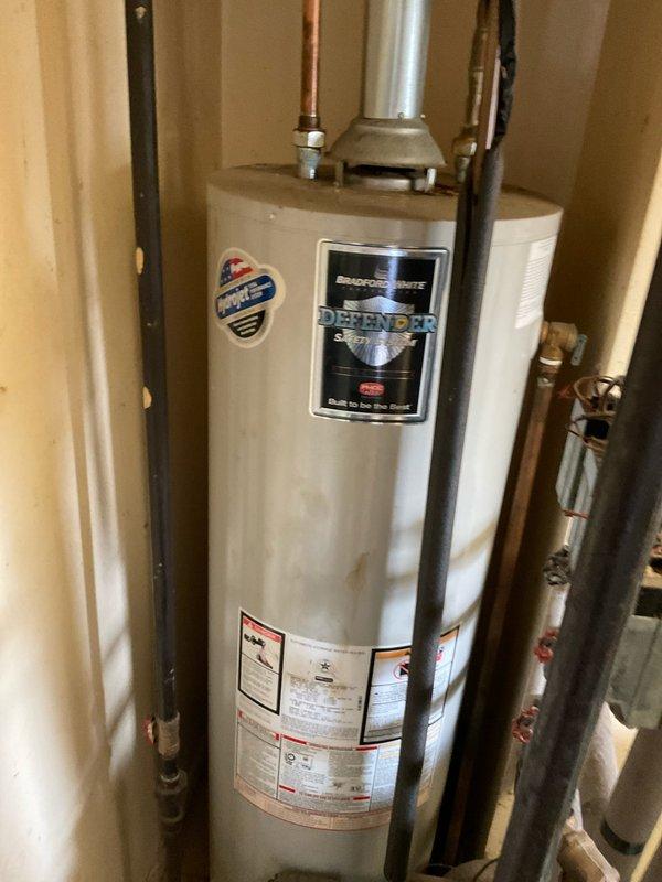 Completed comprehensive boiler system estimate and inspection for commercial facility. Assessed existing water heater installation, including Defender brand unit with associated plumbing connections, pressure relief valves, and copper supply lines. Evaluated insulated ductwork penetration through wall system and documented ceiling infrastructure conditions for proposed boiler replacement project.