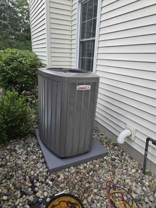 Completed full HVAC system installation in basement mechanical room, including 110,000 BTU gas furnace with PVC venting, 4-ton air conditioning condenser unit positioned on left side of residence, and whole-home humidifier integration. Condenser installed on composite pad with proper drainage stone bedding, all refrigerant lines connected and charged to manufacturer specifications. System tested and operational with all ductwork connections secured and financing documentation processed through Michigan Saves program.