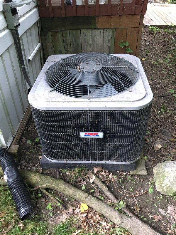 # HVAC Service Completed

Responded to no cooling complaint on 10+ year old Heil air conditioning system. Upon arrival, confirmed outdoor condensing unit had power and fan operation, but unit was not producing cold air. Removed access panel to inspect electrical components and found failed capacitor preventing compressor from starting. Capacitor showed visible signs of deterioration and tested outside acceptable range. Replaced defective dual-run capacitor with proper replacement rated for system specifications. Cleared accumulated debris including leaves and dirt from around unit base and exterior surfaces to ensure proper airflow. Verified all electrical connections were secure and properly terminated. Restored power to system and confirmed compressor engaged properly with new capacitor installed. Tested system operation through complete cooling cycle and verified cold air discharge at indoor registers. Unit operating within normal parameters upon departure.