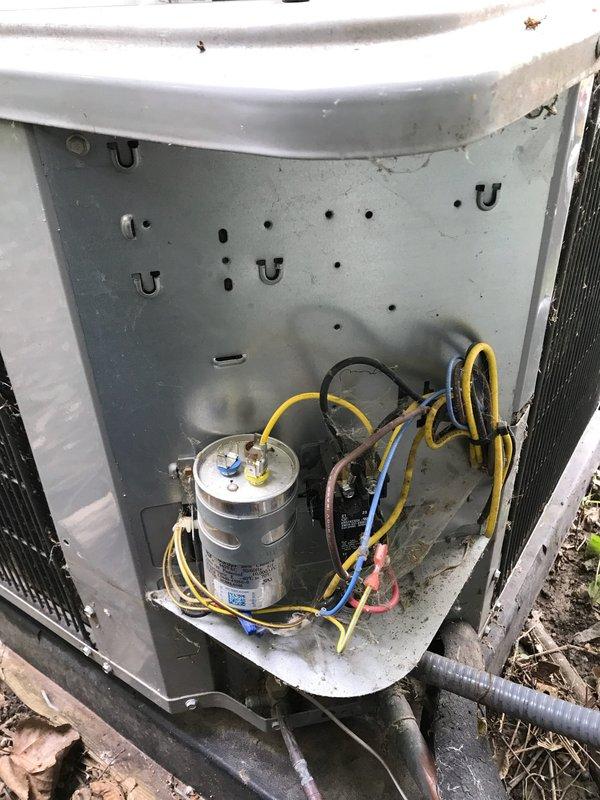 # HVAC Service Completed

Responded to no cooling complaint on 10+ year old Heil air conditioning system. Upon arrival, confirmed outdoor condensing unit had power and fan operation, but unit was not producing cold air. Removed access panel to inspect electrical components and found failed capacitor preventing compressor from starting. Capacitor showed visible signs of deterioration and tested outside acceptable range. Replaced defective dual-run capacitor with proper replacement rated for system specifications. Cleared accumulated debris including leaves and dirt from around unit base and exterior surfaces to ensure proper airflow. Verified all electrical connections were secure and properly terminated. Restored power to system and confirmed compressor engaged properly with new capacitor installed. Tested system operation through complete cooling cycle and verified cold air discharge at indoor registers. Unit operating within normal parameters upon departure.