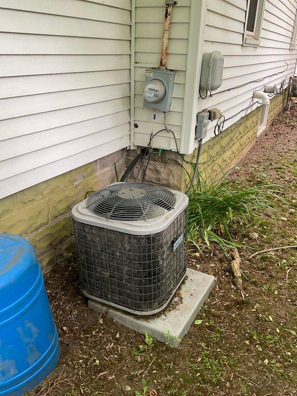 Performed estimate for residential HVAC system replacement. Evaluated 15-year-old flat R-410A air conditioning system that was recharged last year. Upon inspection of outdoor condenser unit on concrete pad and indoor furnace with ductwork in basement, determined system age and condition warrant full replacement rather than additional refrigerant recharge or leak repair services. Documented equipment condition with photographs showing exterior condenser unit, electrical disconnect, indoor furnace, air handler with filter housing, and associated ductwork. Provided replacement recommendation due to system age exceeding typical service life expectancy.