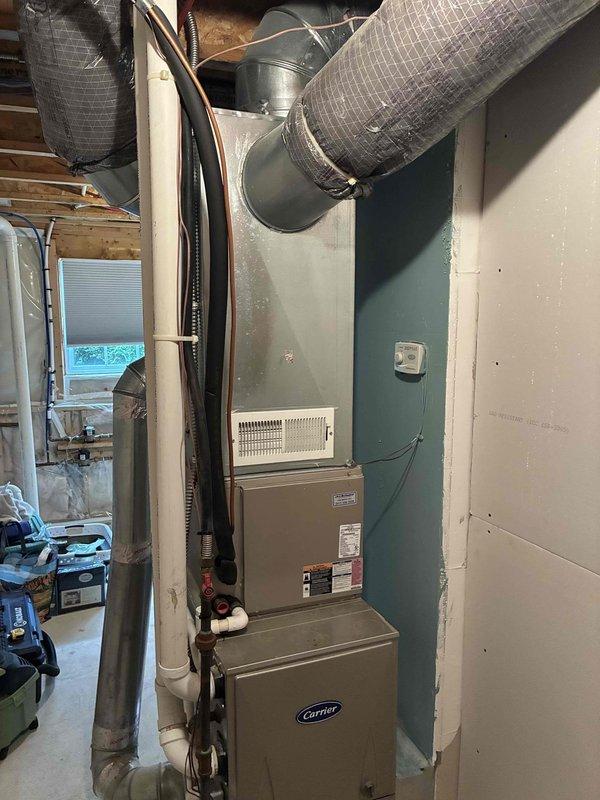 Conducted comprehensive site assessment for complete HVAC system replacement. Evaluated existing Carrier furnace installation in basement utility area and outdoor condensing unit exhibiting severe rust corrosion and weather deterioration on top grille assembly. Documented current system configuration including ductwork connections, refrigerant line routing, electrical controls, and thermostat placement. Prepared multiple equipment replacement quotes covering various system capacity and efficiency options to address failing outdoor unit and coordinate with existing indoor components.