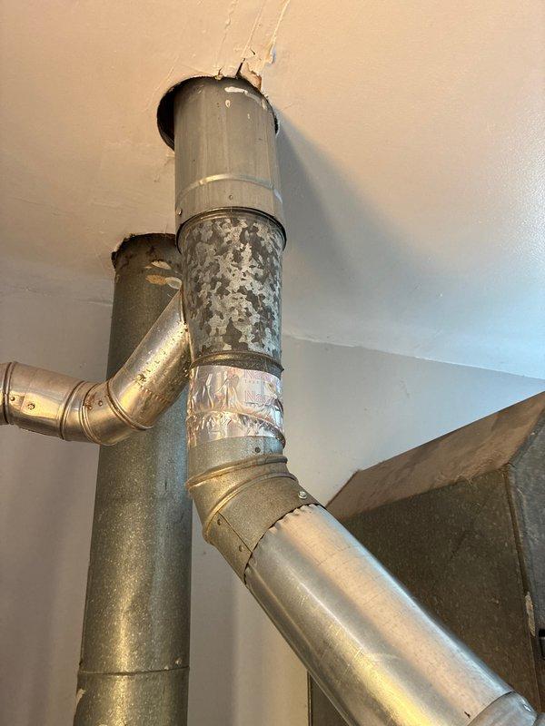 Completed installation of 2-ton air conditioning system with matching evaporator coil on right side of existing furnace setup. Unit was installed in residential mechanical space with proper refrigerant line connections, electrical hookup, and condensate drain routing. System was fully reconnected, tested for proper operation, and verified for adequate airflow through existing ductwork. Installation included coordination with financing approval and all work performed to manufacturer specifications and local code requirements.