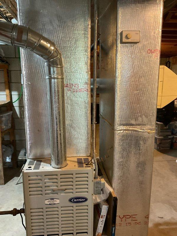 Provided comprehensive estimate for complete HVAC system replacement in basement location. Existing 29-year-old system evaluated with operational natural gas furnace but non-functional air conditioning unit. Assessment included existing Carrier equipment configuration, ductwork connections, and plenum assembly to determine appropriate replacement specifications for both heating and cooling components.