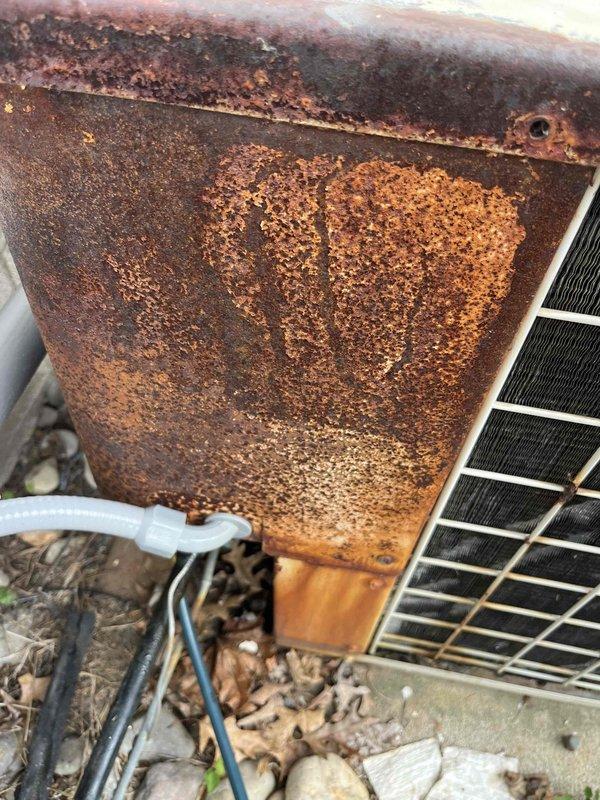 Responded to no cooling complaint on air conditioning system. Upon inspection, found severely corroded outdoor unit cabinet panel with extensive rust damage compromising structural integrity and potentially affecting unit performance. Observed significant deterioration on metal surfaces indicating prolonged moisture exposure and weathering. Inspected attic space and indoor components, noting insulation condition and ductwork connections. Documented equipment condition with photographs showing corroded outdoor unit panel and attic area for service records and recommended repairs.