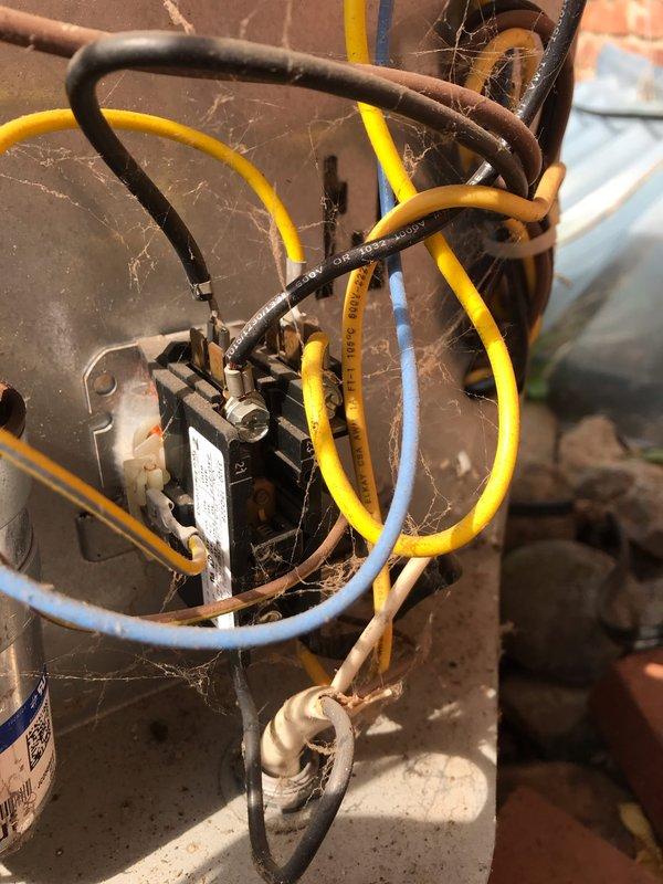 # HVAC Service Completed

Responded to no cooling call with unit not operating. Upon arrival, found outdoor condensing unit completely inoperative with no power to system. Performed diagnostic evaluation of electrical components and identified failed dual run capacitor as primary cause of system failure. Capacitor showed visible signs of deterioration and tested outside acceptable microfarad range.

Replaced defective Genteq capacitor with new OEM-equivalent dual run capacitor rated to manufacturer specifications. Cleaned electrical connections and terminals that showed oxidation and corrosion from outdoor exposure. Verified all wire connections were secure and properly terminated. Cycled system through multiple start sequences to confirm proper compressor and condenser fan motor operation. Unit now cooling effectively with all components functioning within normal parameters. Recommended routine maintenance to address accumulated debris and biological growth on outdoor unit for optimal