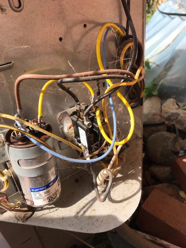 # HVAC Service Completed

Responded to no cooling call with unit not operating. Upon arrival, found outdoor condensing unit completely inoperative with no power to system. Performed diagnostic evaluation of electrical components and identified failed dual run capacitor as primary cause of system failure. Capacitor showed visible signs of deterioration and tested outside acceptable microfarad range.

Replaced defective Genteq capacitor with new OEM-equivalent dual run capacitor rated to manufacturer specifications. Cleaned electrical connections and terminals that showed oxidation and corrosion from outdoor exposure. Verified all wire connections were secure and properly terminated. Cycled system through multiple start sequences to confirm proper compressor and condenser fan motor operation. Unit now cooling effectively with all components functioning within normal parameters. Recommended routine maintenance to address accumulated debris and biological growth on outdoor unit for optimal