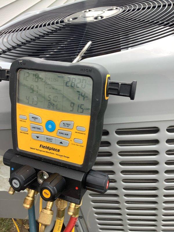 Performed comprehensive AC tune-up and system diagnostics on outdoor condensing unit. Connected digital manifold gauges to measure refrigerant pressures and temperatures, verifying proper system operation and superheat levels. Inspected electrical components and capacitor, noting visible corrosion and rust accumulation on capacitor terminals and connection points that will require monitoring or future replacement to prevent electrical failure.