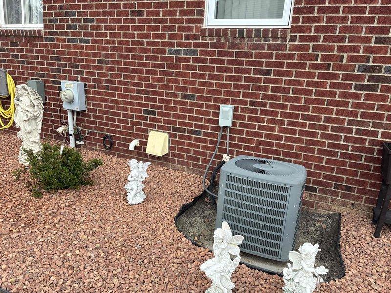 Provided comprehensive estimate for complete HVAC system replacement including outdoor air conditioning unit and indoor furnace with 15-year-old existing equipment currently non-operational. Assessed exterior condensing unit positioned on concrete pad adjacent to electrical disconnect and meter, along with basement furnace installation located near water heater with existing ductwork infrastructure. Documented equipment specifications and site conditions for whole system replacement proposal.