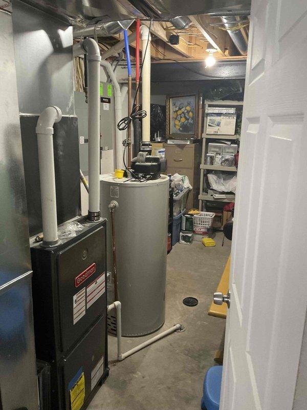 Provided comprehensive estimate for complete HVAC system replacement including outdoor air conditioning unit and indoor furnace with 15-year-old existing equipment currently non-operational. Assessed exterior condensing unit positioned on concrete pad adjacent to electrical disconnect and meter, along with basement furnace installation located near water heater with existing ductwork infrastructure. Documented equipment specifications and site conditions for whole system replacement proposal.