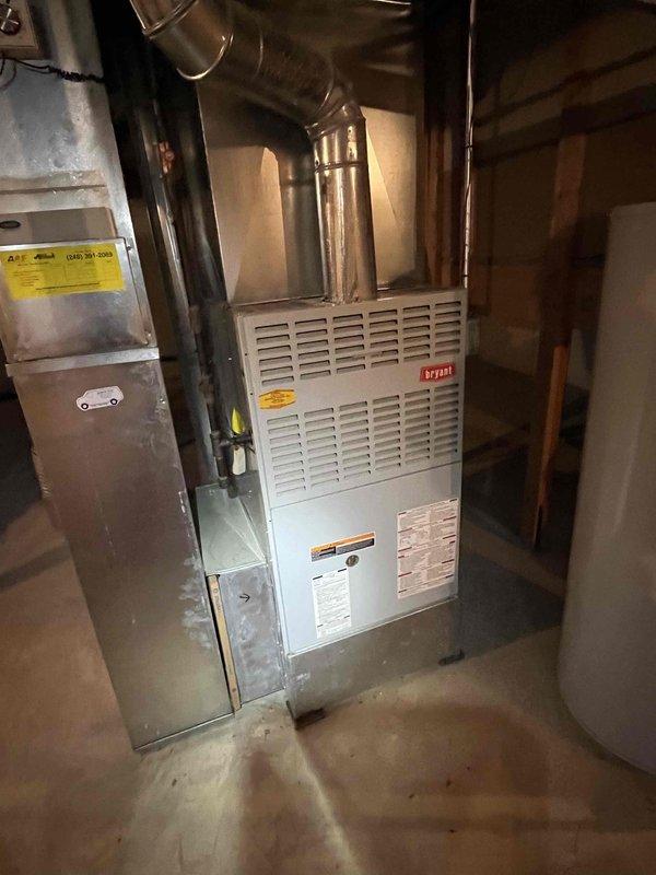 Responded to no cooling complaint on TempStar air conditioning system. Upon arrival, performed diagnostic evaluation of both indoor Bryant furnace/air handler and outdoor condensing unit. Inspected electrical connections, refrigerant line sets, and service valves at outdoor unit. Verified system operation and checked for proper airflow at indoor equipment. Documented equipment condition with photos showing furnace installation in basement utility area and outdoor condenser unit positioned on concrete pad with service valves accessible for maintenance.