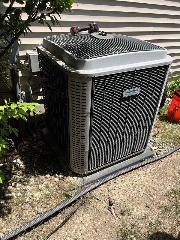 Responded to no cooling complaint on TempStar air conditioning system. Upon arrival, performed diagnostic evaluation of both indoor Bryant furnace/air handler and outdoor condensing unit. Inspected electrical connections, refrigerant line sets, and service valves at outdoor unit. Verified system operation and checked for proper airflow at indoor equipment. Documented equipment condition with photos showing furnace installation in basement utility area and outdoor condenser unit positioned on concrete pad with service valves accessible for maintenance.
