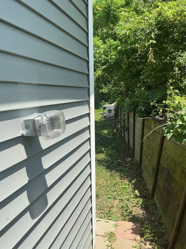 Installed a new Type 3R weatherproof GFCI outlet enclosure on the exterior of the residence. The Intermatic while-in-use cover with clear hinged lid was mounted to the building's vinyl siding, providing protected access to a dual receptacle GFCI device with test and reset functionality. The installation ensures code-compliant ground fault protection for outdoor electrical use while maintaining weather resistance when the outlet is in operation.