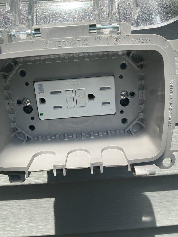 Installed a new Type 3R weatherproof GFCI outlet enclosure on the exterior of the residence. The Intermatic while-in-use cover with clear hinged lid was mounted to the building's vinyl siding, providing protected access to a dual receptacle GFCI device with test and reset functionality. The installation ensures code-compliant ground fault protection for outdoor electrical use while maintaining weather resistance when the outlet is in operation.