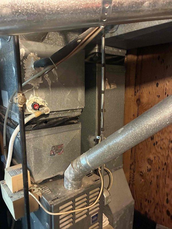 Provided comprehensive estimate for complete HVAC system replacement including 28-30 year old natural gas furnace located in basement and air conditioning unit in backyard. Current AC unit operational but low on R22 refrigerant, while furnace remains functional. Assessed existing equipment, ductwork connections, gas line configuration, and installation requirements for new high-efficiency replacement systems.