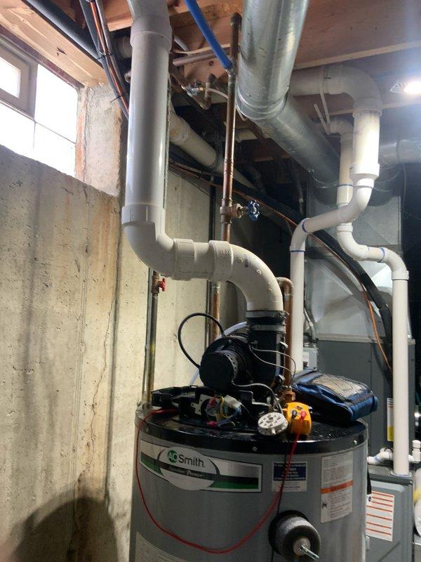 Responded to emergency service call for non-functioning water heater at residential property. Upon arrival, assessed existing A.O. Smith tanked water heater system in basement utility area and determined unit had failed beyond economical repair. Completed full water heater replacement, installing new unit with proper venting through existing PVC flue system. Reconnected all copper supply and distribution lines, installed new shut-off valves, and verified proper operation of recirculation pump mounted on top of tank. Tested temperature and pressure relief valve, confirmed adequate drainage provisions, and ensured all connections were secure and leak-free. System restored to full operational status with hot water service confirmed throughout residence.