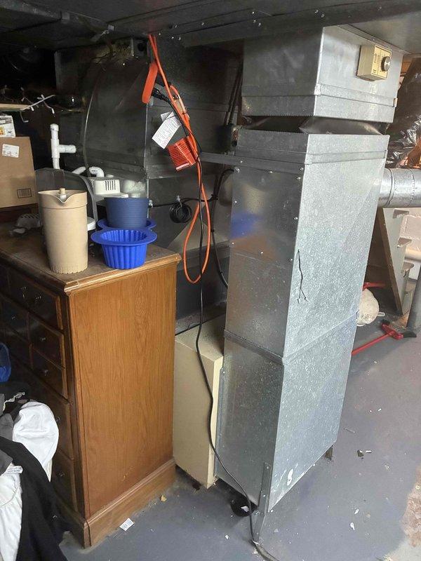 Conducted on-site evaluation of existing 15+ year old air conditioning system to provide replacement estimate. Assessed current HVAC equipment configuration in basement installation, including air handling unit and associated ductwork connections. Documented existing system layout and components through photographic records, capturing metallic air handling unit, Goodman furnace, flexible and rigid ductwork, and basement infrastructure. Discussed replacement options and financing terms for new air conditioning system to address aging equipment concerns.