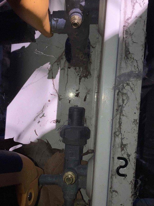 # HVAC Service Report - No Cooling Condition

Responded to service call for air conditioning system not cooling on unit over 10 years old. Upon arrival, performed diagnostic evaluation of the system to identify the root cause of the no-cool condition.

Conducted electrical testing using digital multimeter to measure voltage and verify power supply to critical components. Testing revealed voltage reading of 352.8 volts at the service disconnect or compressor circuit, indicating potential electrical issues affecting system operation. Inspected refrigerant line connections and associated piping components in the mechanical area, noting visible deterioration of surrounding surfaces and infrastructure consistent with the age of the equipment.

Performed hands-on inspection of refrigerant piping, valves, and connection points to check for proper installation, potential refrigerant leaks, or mechanical failures. Given the advanced age of the unit (10+ years), assessed overall system condition