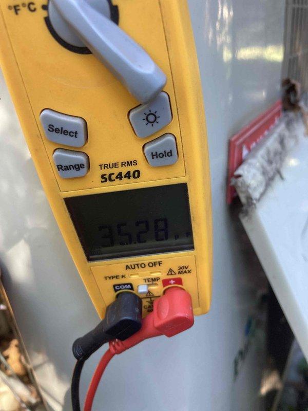 # HVAC Service Report - No Cooling Condition

Responded to service call for air conditioning system not cooling on unit over 10 years old. Upon arrival, performed diagnostic evaluation of the system to identify the root cause of the no-cool condition.

Conducted electrical testing using digital multimeter to measure voltage and verify power supply to critical components. Testing revealed voltage reading of 352.8 volts at the service disconnect or compressor circuit, indicating potential electrical issues affecting system operation. Inspected refrigerant line connections and associated piping components in the mechanical area, noting visible deterioration of surrounding surfaces and infrastructure consistent with the age of the equipment.

Performed hands-on inspection of refrigerant piping, valves, and connection points to check for proper installation, potential refrigerant leaks, or mechanical failures. Given the advanced age of the unit (10+ years), assessed overall system condition