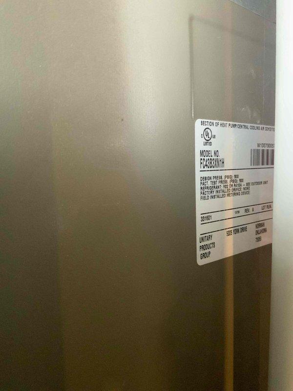 Responded to no cooling complaint on Goodman model FC4C60A1H heat pump system. Upon arrival, performed visual inspection and diagnostic assessment of the unit. Documented equipment nameplate information and current system condition through photographic records for service documentation purposes. Unit was confirmed to be under 10 years old based on serial number verification.