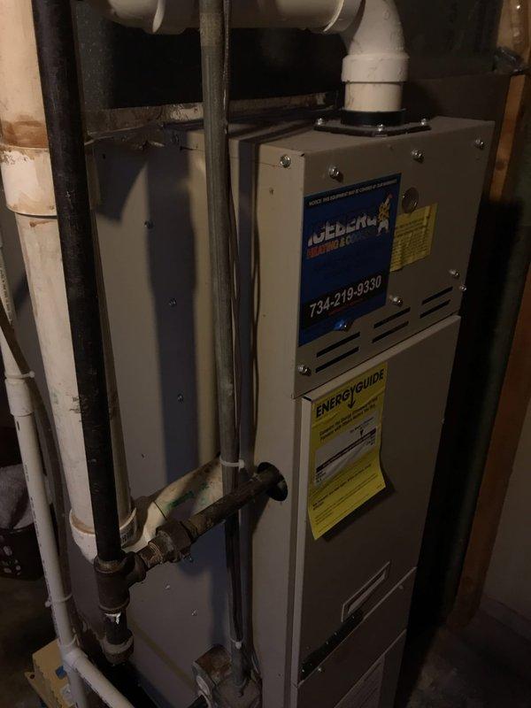 Responded to service call for air conditioning system experiencing freeze-up on evaporator coil while still providing cooling. Upon arrival, inspected 12-year-old residential AC system and found electrical compartment of outdoor condenser unit heavily soiled with dirt, debris, and organic matter accumulation. Electrical connections showed signs of age and weathering with visible discoloration on wire insulation. Condenser coil fins exhibited dirt buildup affecting airflow and heat transfer efficiency. Indoor furnace unit appeared serviceable with proper venting configuration. Documented system condition through photography for customer records. Provided diagnosis of freeze-up condition likely caused by restricted airflow from dirty coil and components, combined with age-related wear on electrical connections. Advised customer of findings and recommended thorough system cleaning, coil maintenance, and electrical connection inspection to restore proper operation and prevent future freeze