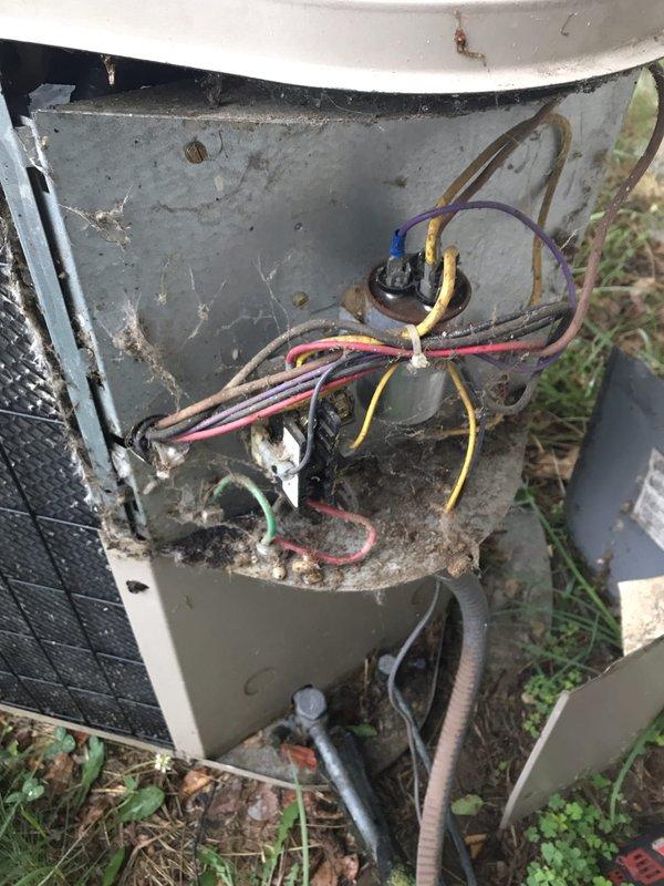 Responded to service call for air conditioning system experiencing freeze-up on evaporator coil while still providing cooling. Upon arrival, inspected 12-year-old residential AC system and found electrical compartment of outdoor condenser unit heavily soiled with dirt, debris, and organic matter accumulation. Electrical connections showed signs of age and weathering with visible discoloration on wire insulation. Condenser coil fins exhibited dirt buildup affecting airflow and heat transfer efficiency. Indoor furnace unit appeared serviceable with proper venting configuration. Documented system condition through photography for customer records. Provided diagnosis of freeze-up condition likely caused by restricted airflow from dirty coil and components, combined with age-related wear on electrical connections. Advised customer of findings and recommended thorough system cleaning, coil maintenance, and electrical connection inspection to restore proper operation and prevent future freeze