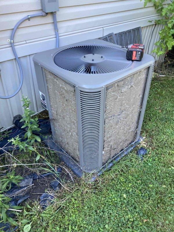 Completed preventive maintenance tune-up on residential HVAC system. Inspected indoor air handler unit and replaced 20x25x1 EZ Flow air filter, checked electrical connections and control board functionality. Serviced outdoor condensing unit, cleared vegetation growth from around base and perimeter, verified proper airflow through condenser coils and confirmed fan operation.