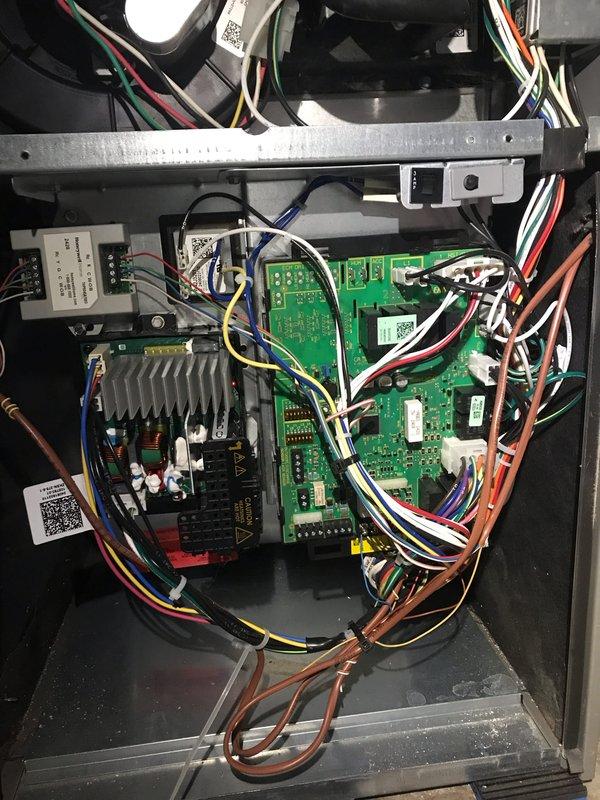 Responded to no cooling call and performed diagnostic inspection of HVAC system. Upon arrival, conducted visual inspection of air handler components including blower assembly and control board. Examined squirrel cage blower wheel for debris accumulation, blade integrity, and proper clearances within housing. Inspected main control board for signs of electrical failure, burnt components, or loose connections. Verified all wire harnesses and connectors were properly seated and secure. Checked relay contacts and fuse integrity on control panel. System evaluated and photographed for documentation purposes.