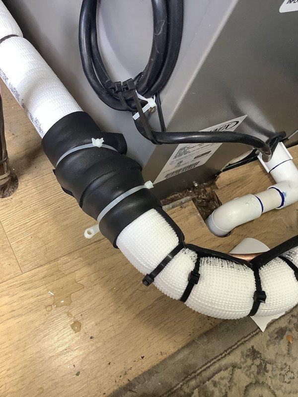 Responded to callback for possible refrigerant leak at evaporator coil. Inspected refrigerant line connections and coil assembly, documented insulated linesets and condensate drain configuration with securing straps. Visual inspection completed of mechanical connections and pipe joints at unit base to identify source of reported leak.